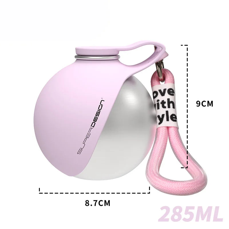 PawSip bottle clipped to bag strap during outdoor walk