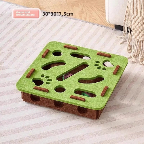 Cat pawing into the felt puzzle maze holes